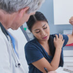woman talking to doctor about shoulder pain