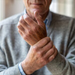 man holding wrist in pain