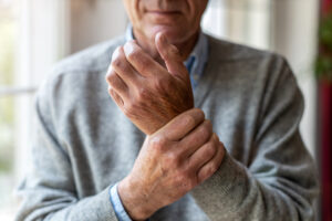 man holding wrist in pain
