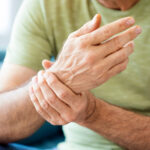 Older man holding his wrist in pain